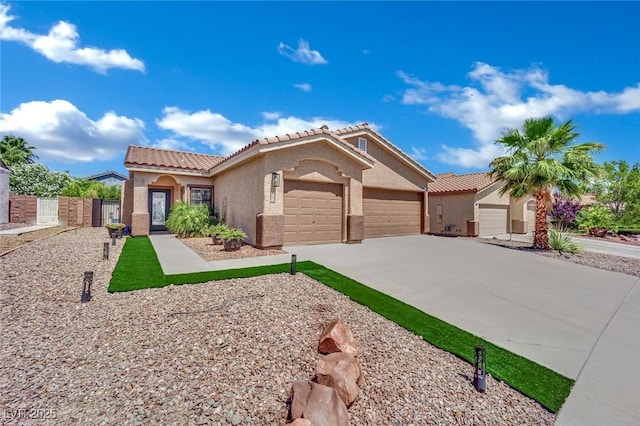 2558 Wiltshire Ave, Henderson, NV 89052 - view of front facade featuring stucco siding, an attached garage, a tiled roof, and concrete driveway