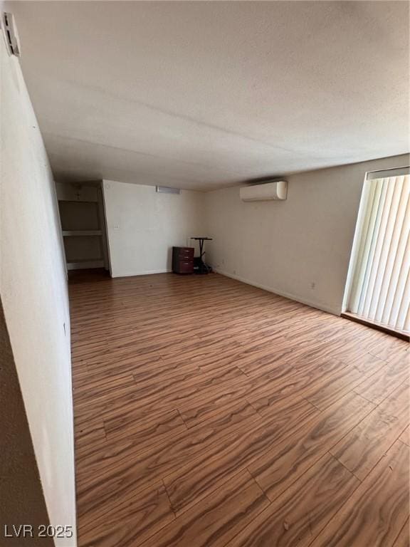 2604 Webster St, North Las Vegas, NV 89030 - unfurnished room with an AC wall unit and wood finished floors