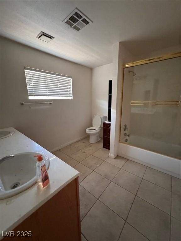2604 Webster St, North Las Vegas, NV 89030 - full bathroom featuring tile patterned floors, double vanity, shower / bathtub combination, baseboards, and toilet