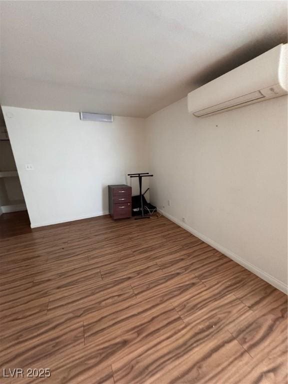 2604 Webster St, North Las Vegas, NV 89030 - finished below grade area with an AC wall unit, wood finished floors, and baseboards