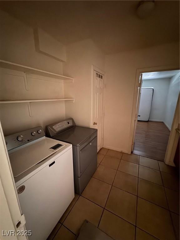 2604 Webster St, North Las Vegas, NV 89030 - laundry area featuring independent washer and dryer and tile patterned flooring