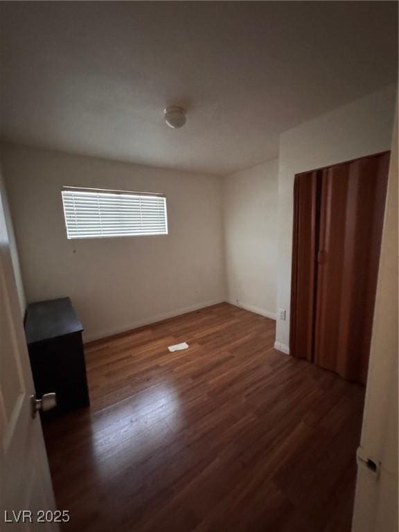 2604 Webster St, North Las Vegas, NV 89030 - unfurnished bedroom with wood finished floors and baseboards