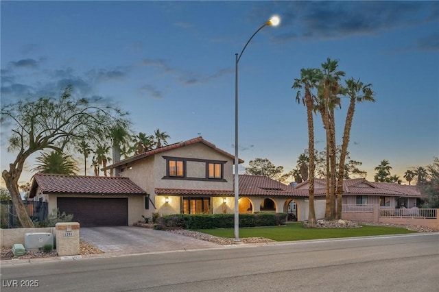1251 Los Meadows Dr, Las Vegas, NV 89110 - mediterranean / spanish-style home with an attached garage, stucco siding, a tiled roof, and driveway