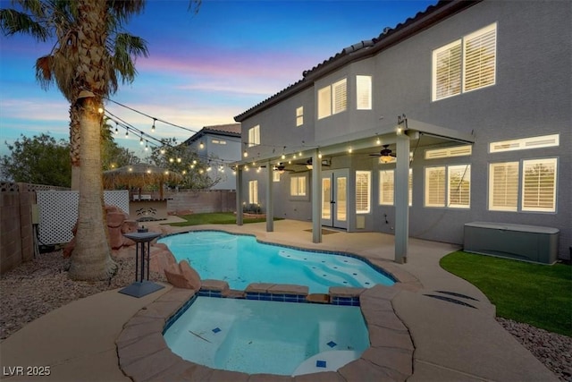 3204 Rutledge Dr, Las Vegas, NV 89120 - pool at dusk with a fenced backyard, ceiling fan, a patio, french doors, and a pool with connected hot tub