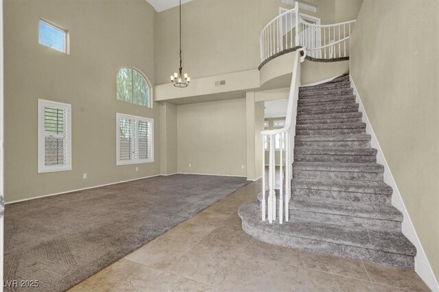 3204 Rutledge Dr, Las Vegas, NV 89120 - stairs with plenty of natural light, carpet, a high ceiling, a chandelier, and baseboards