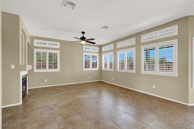3204 Rutledge Dr, Las Vegas, NV 89120 - empty room with a ceiling fan, a lit fireplace, tile patterned floors, and baseboards
