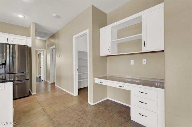 3204 Rutledge Dr, Las Vegas, NV 89120 - kitchen featuring stainless steel fridge, white cabinets, open shelves, baseboards, and tile patterned flooring