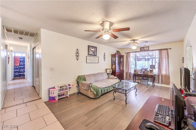 5809 Robin Ln, Las Vegas, NV 89108 - living room with plenty of natural light, ceiling fan, a textured ceiling, and tile patterned flooring