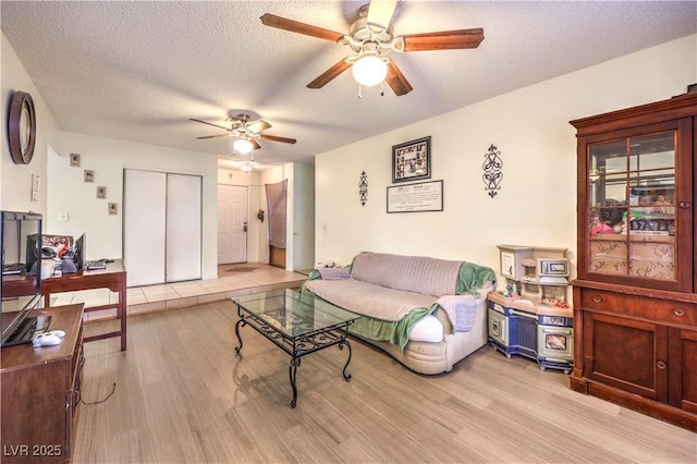 5809 Robin Ln, Las Vegas, NV 89108 - living area with ceiling fan, light wood-style flooring, and a textured ceiling