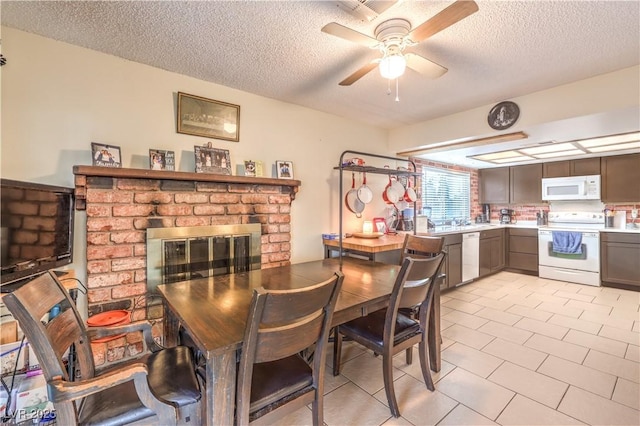 5809 Robin Ln, Las Vegas, NV 89108 - dining room featuring a textured ceiling, ceiling fan, a brick fireplace, and light tile patterned floors