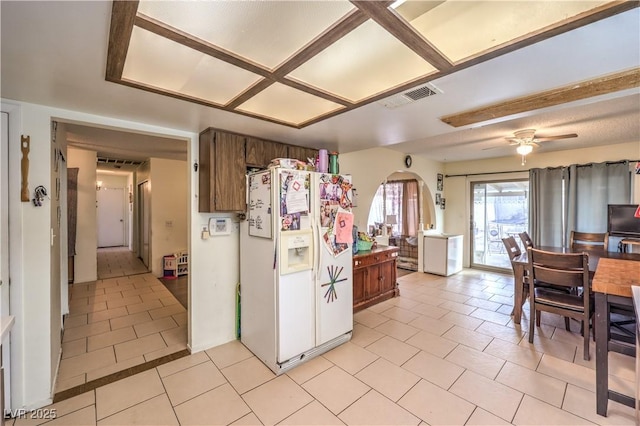 5809 Robin Ln, Las Vegas, NV 89108 - kitchen featuring white fridge with ice dispenser, light tile patterned floors, and a ceiling fan