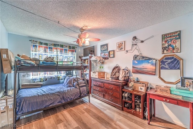 5809 Robin Ln, Las Vegas, NV 89108 - bedroom featuring wood finished floors, a textured ceiling, and a ceiling fan