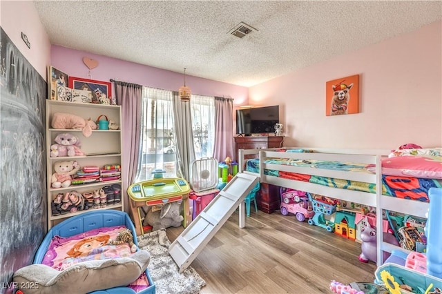 5809 Robin Ln, Las Vegas, NV 89108 - bedroom featuring a textured ceiling and wood finished floors