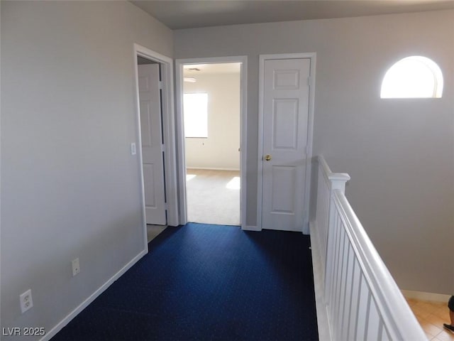 2905 Shimmering Bay St, Laughlin, NV 89029 - corridor with an upstairs landing, baseboards, and dark carpet