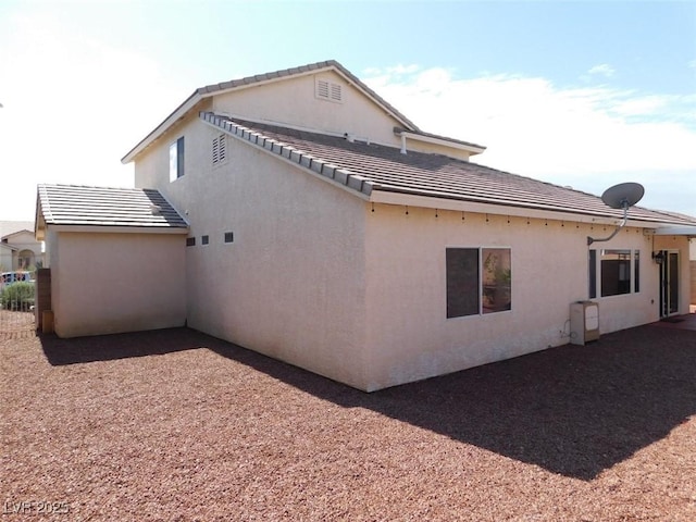2905 Shimmering Bay St, Laughlin, NV 89029 - view of side of home with a tiled roof and stucco siding