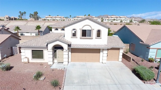 2905 Shimmering Bay St, Laughlin, NV 89029 - view of front facade with stucco siding, a residential view, concrete driveway, and a garage