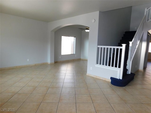 2905 Shimmering Bay St, Laughlin, NV 89029 - spare room with arched walkways, light tile patterned floors, stairs, and a ceiling fan