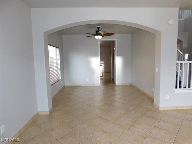 2905 Shimmering Bay St, Laughlin, NV 89029 - empty room featuring arched walkways, light tile patterned floors, a ceiling fan, and baseboards