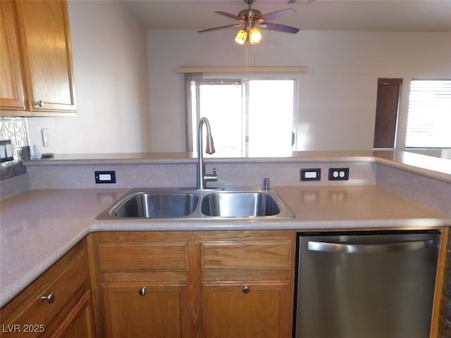 2905 Shimmering Bay St, Laughlin, NV 89029 - kitchen featuring stainless steel dishwasher, a sink, ceiling fan, light countertops, and brown cabinetry