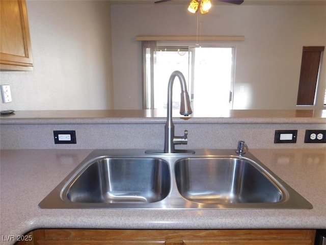 2905 Shimmering Bay St, Laughlin, NV 89029 - kitchen view of a sink, a ceiling fan, and light countertops