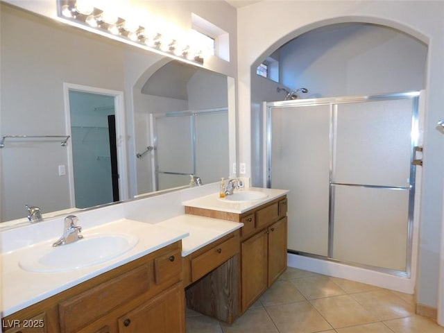 2905 Shimmering Bay St, Laughlin, NV 89029 - bathroom with a stall shower, double vanity, tile patterned flooring, and a walk in closet