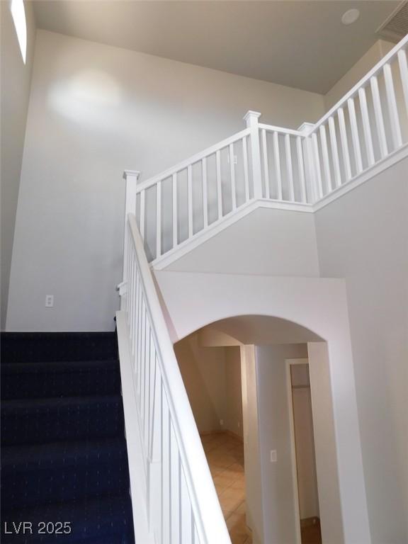 2905 Shimmering Bay St, Laughlin, NV 89029 - stairs with arched walkways and tile patterned flooring