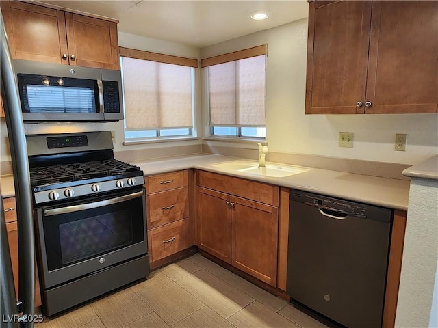 2106 Pebble Creek Ln, Laughlin, NV 89029 - kitchen featuring appliances with stainless steel finishes, a sink, light countertops, recessed lighting, and brown cabinetry