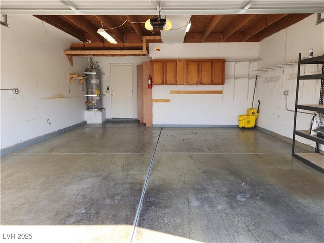 2106 Pebble Creek Ln, Laughlin, NV 89029 - garage featuring secured water heater, a garage door opener, and baseboards
