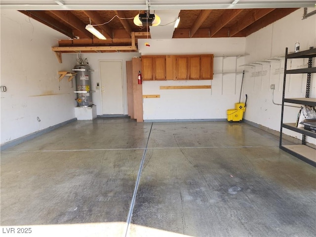 2106 Pebble Creek Ln, Laughlin, NV 89029 - garage with strapped water heater, a garage door opener, and baseboards