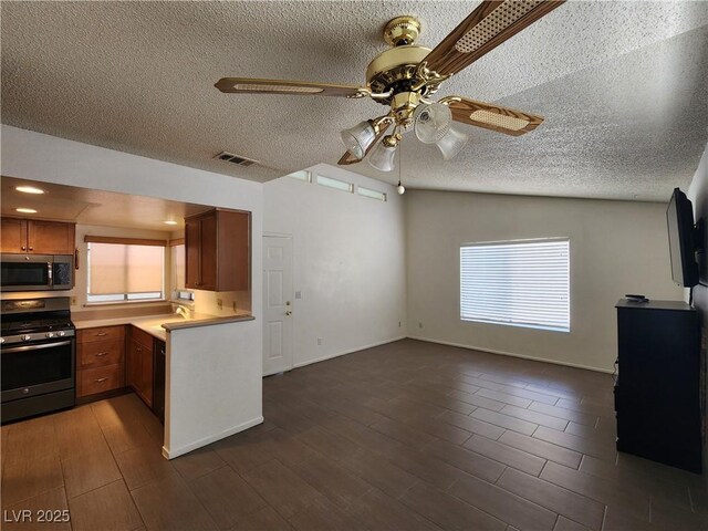 2106 Pebble Creek Ln, Laughlin, NV 89029 - kitchen with stainless steel appliances, ceiling fan, light countertops, a textured ceiling, and a sink
