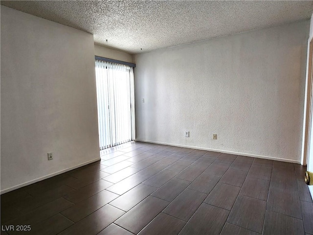 2106 Pebble Creek Ln, Laughlin, NV 89029 - unfurnished room featuring a textured ceiling, wood tiled floors, baseboards, and a textured wall