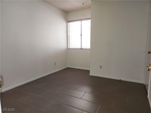 2106 Pebble Creek Ln, Laughlin, NV 89029 - spare room with a textured ceiling and baseboards