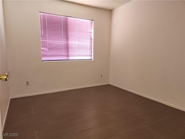 2106 Pebble Creek Ln, Laughlin, NV 89029 - spare room featuring a textured ceiling and baseboards