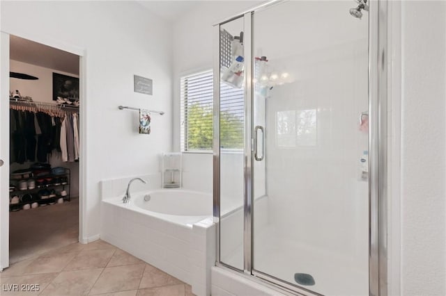 10329 Walworth Ave, Las Vegas, NV 89166 - full bathroom featuring a bath, a stall shower, tile patterned floors, and a walk in closet