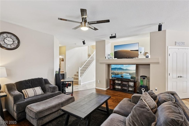 10329 Walworth Ave, Las Vegas, NV 89166 - living area with ceiling fan, wood finished floors, stairway, and baseboards