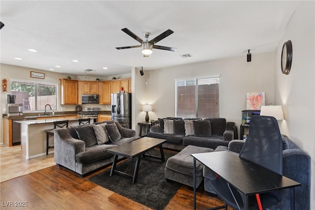 10329 Walworth Ave, Las Vegas, NV 89166 - living room with ceiling fan, light wood-style flooring, and recessed lighting
