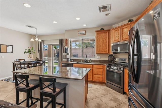 10329 Walworth Ave, Las Vegas, NV 89166 - kitchen featuring stainless steel appliances, a sink, light tile patterned flooring, a kitchen island, and recessed lighting