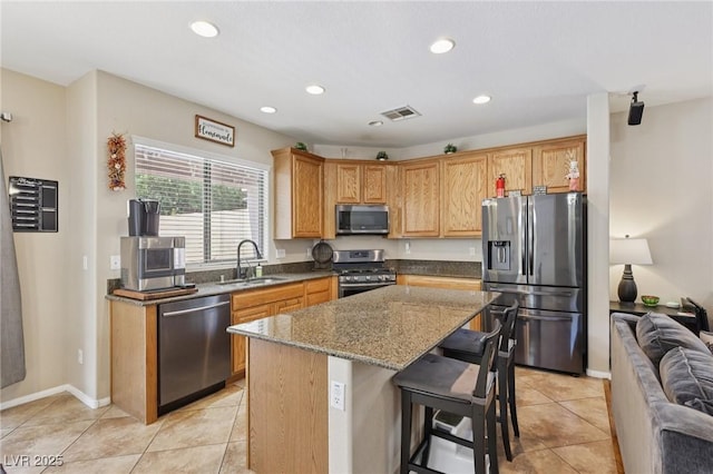10329 Walworth Ave, Las Vegas, NV 89166 - kitchen featuring stainless steel appliances, a sink, stone counters, a kitchen island, and light tile patterned floors
