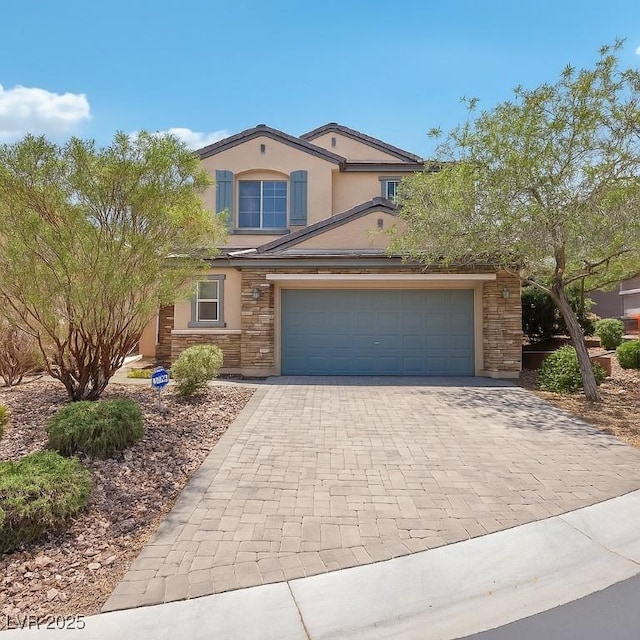 10329 Walworth Ave, Las Vegas, NV 89166 - view of front of property featuring stone siding, decorative driveway, and stucco siding