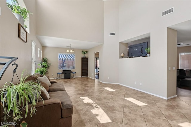 10329 Walworth Ave, Las Vegas, NV 89166 - living room featuring a high ceiling, light tile patterned flooring, baseboards, and a chandelier