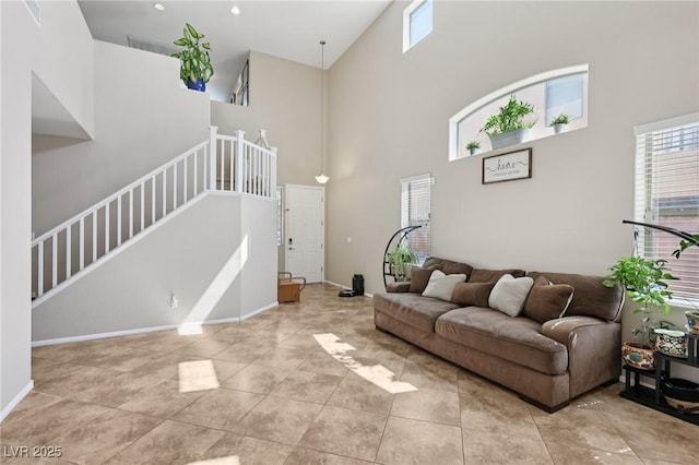 10329 Walworth Ave, Las Vegas, NV 89166 - tiled living room featuring a high ceiling, healthy amount of natural light, stairs, and baseboards