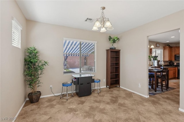10329 Walworth Ave, Las Vegas, NV 89166 - dining room with a chandelier, plenty of natural light, and baseboards
