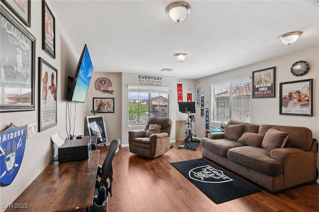 10329 Walworth Ave, Las Vegas, NV 89166 - living room featuring wood-type flooring, a textured ceiling, and baseboards