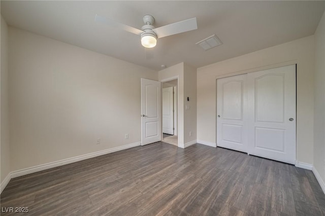 9792 Crescent Lodge Ct, Las Vegas, NV 89178 - unfurnished bedroom with dark wood-type flooring, baseboards, a closet, and a ceiling fan