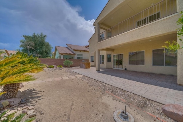 9792 Crescent Lodge Ct, Las Vegas, NV 89178 - back of house featuring stucco siding, a patio area, and a balcony