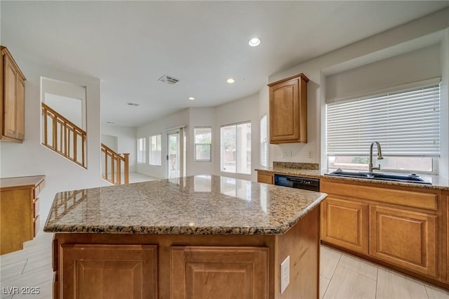 9792 Crescent Lodge Ct, Las Vegas, NV 89178 - kitchen featuring a sink, healthy amount of natural light, a center island, light stone countertops, and recessed lighting