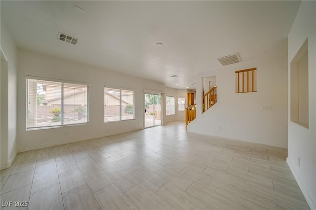 9792 Crescent Lodge Ct, Las Vegas, NV 89178 - unfurnished living room featuring stairs and baseboards
