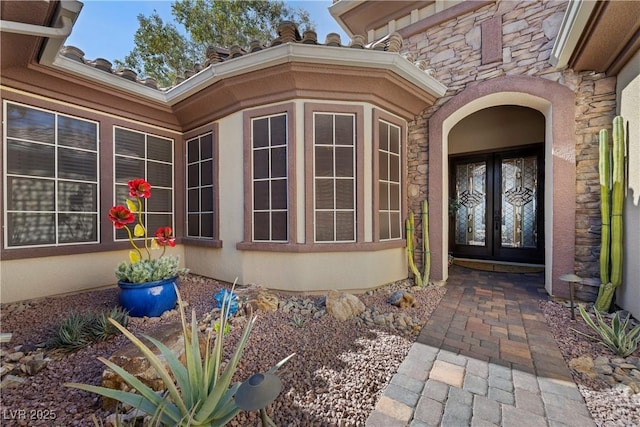2749 Liberation Dr, Henderson, NV 89044 - entrance to property featuring french doors, stone siding, and stucco siding