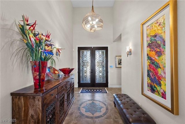 2749 Liberation Dr, Henderson, NV 89044 - foyer featuring french doors, a chandelier, baseboards, a high ceiling, and tile patterned floors