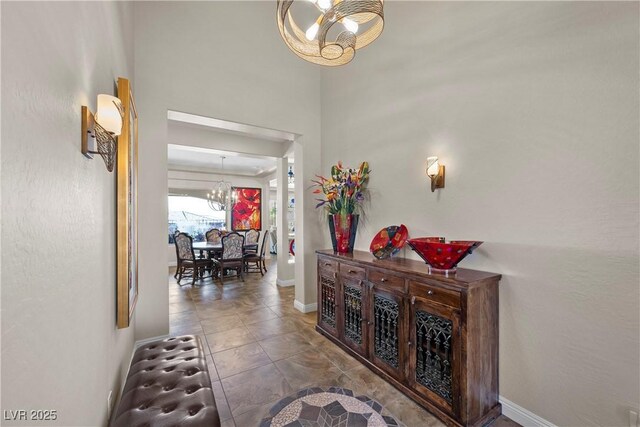 2749 Liberation Dr, Henderson, NV 89044 - corridor featuring a chandelier and baseboards